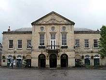 Symmetrical two storey building in classical style with nine bays.