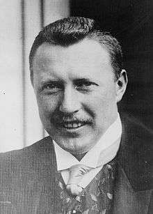 Middle-aged man wearing a tie, waistcoat and jacket.