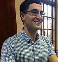 Photograph of Will Kostakis at lectern