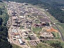 aerial view of a cluster of buildings on a wooded mountainside