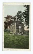 A small wooden building with a small wooden tower on top